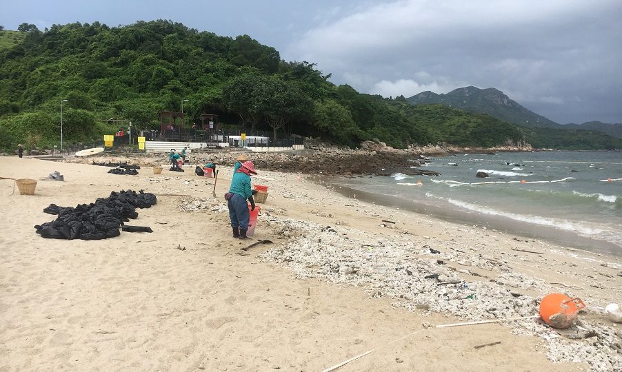 Despite days of hard work on the part of beach cleaners, Hung Shing Yeh Beach on Lamma Island remains dotted with lumps of congealed palm oil. The globules have been washing up on Hong Kong’s shores after two ships — one of which was carrying 9,000 tons of palm oil — crashed in mainland waters. Photo: Rafiaa Rumjahn/Coconuts Media