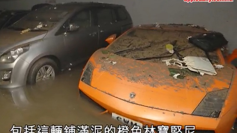 An Orange Lamborghini sits covered in mud with its wheels still in seawater inside the flooded Heng Fa Chuen car park on August 24. Screenshot: Apple Daily