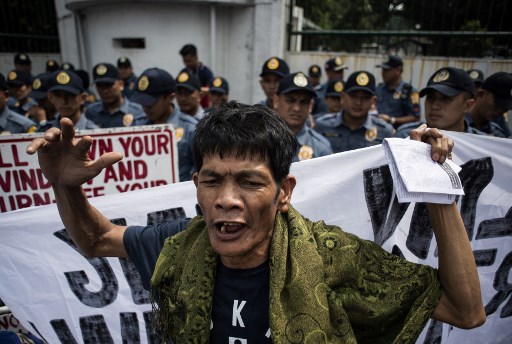 An activist shouts slogans during a protest against Philippine President Rodrigo Duterte in front of the Armed Forces of the Philippines (AFP) headquarters in Manila AFP PHOTO / NOEL CELIS
