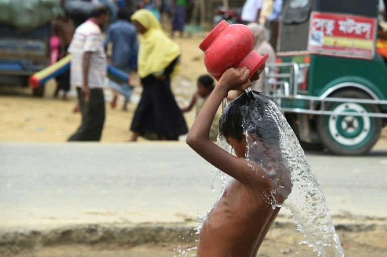 A young Rohingya refugee washes himself at the Thangkhali refugee camp near Ukhia on September 27, 2017.