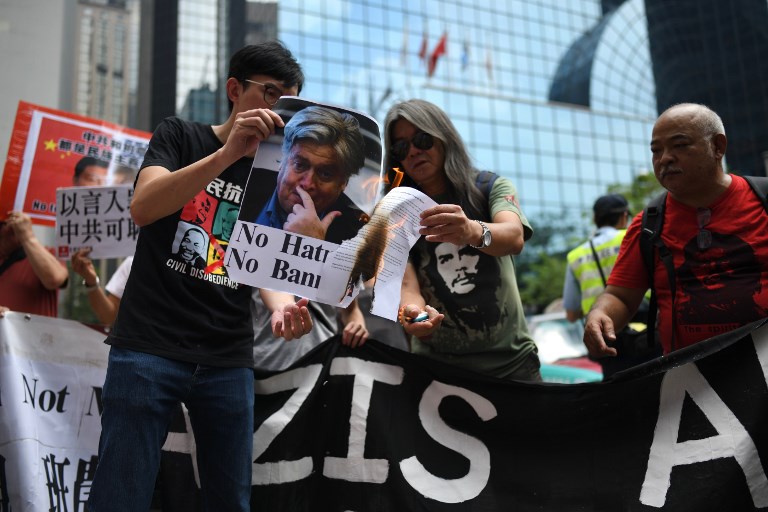 Veteran activist and former Hong Kong lawmaker Leung Kwok-hung (centre R), also known as “Long Hair” and Avery Leung (centre L), chairman of the League of Social Democrats (LSD), burn a picture (L) of former White House chief strategist Steve Bannon during a protest against US President Donald Trump and Bannon’s visit to the city ahead of his expected speech for an investment firm in Hong Kong on September 12, 2017.
AFP PHOTO / Anthony Wallace