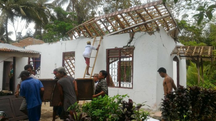 Locals help in the clean up of a collapsed church in a village in Cilacap, Central Java. Photo: Tribun