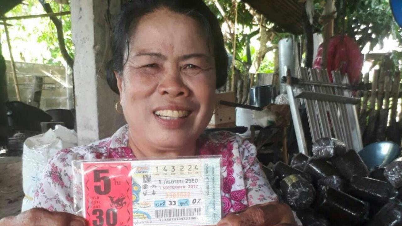 The photo, which has been shared widely, shows the family’s 60-year-old grandmother, Luan Thananchai, holding a set of fake winning tickets with a big smile on her face. 
