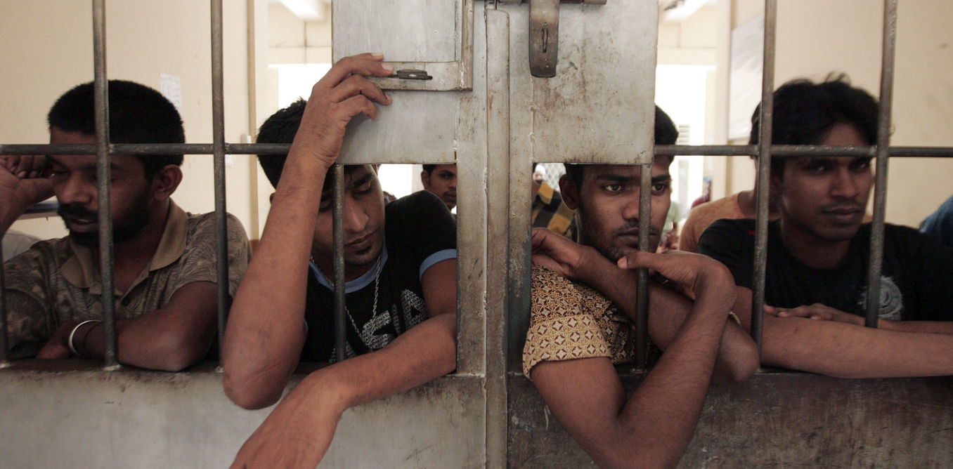 Illegal migrants from Myanmar stand at the gate of an immigration detention centre in Medan in Indonesia’s North Sumatra province April 5, 2013. Eight illegal migrants were killed after a brawl between Buddhist and Muslim asylum seekers from Myanmar, a police official said on Friday. Photo: REUTERS/Roni Bintang 
