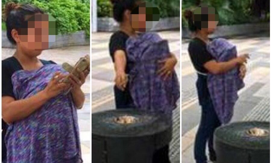 The woman is seen carrying what believed to be a baby covered by a blanket while smoking. Photo: Support Group for HK Employers with FDHs/Facebook