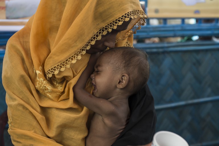 In this picture taken on October 1, 2017, a Rohingya Muslim refugee holds her child as she waits to see a doctor at a medical centre at Balukhali refugee camp near the town of Gumdhum in Cox’s Bazar. Photo: AFP / FRED DUFOUR