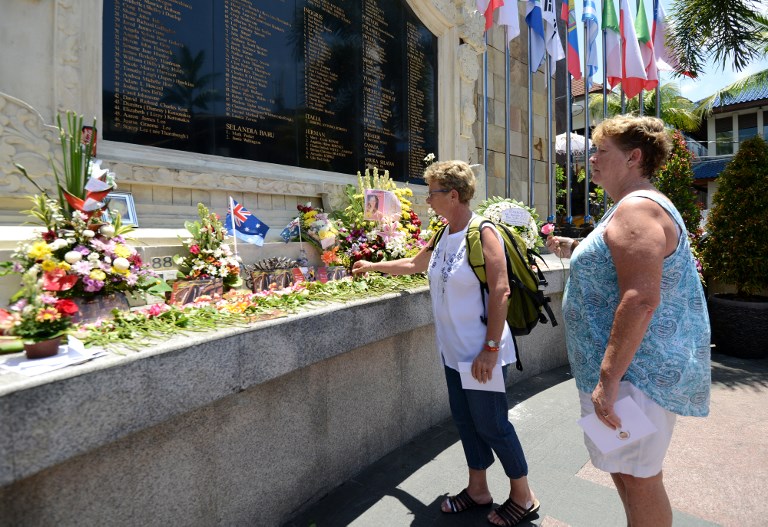 Foreign tourists visit the memorial for victims of the 2002 Bali bombings during the 15th anniversary of the blasts in the Kuta tourist area near Denpasar, Bali on October 12, 2017. The 2002 blast, blamed on the militant Jemaah Islamiyah network linked to Al-Qaeda, tore apart a busy nightclub strip on the resort island of Bali killing 202 people, including 88 Australians. Photo: Sonny Tumbelaka/AFP