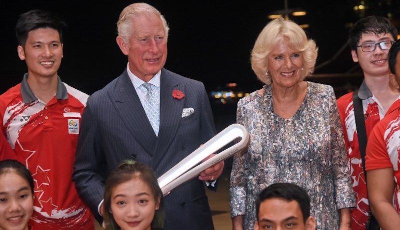 Britain’s Prince Charles and Duchess of Cornwall Camilla pose for photograph with Singaporean athletes during a handover of the Queen’s Commonwealth Baton in Singapore on October 30, 2017. Photo: Roslan Rahman/AFP