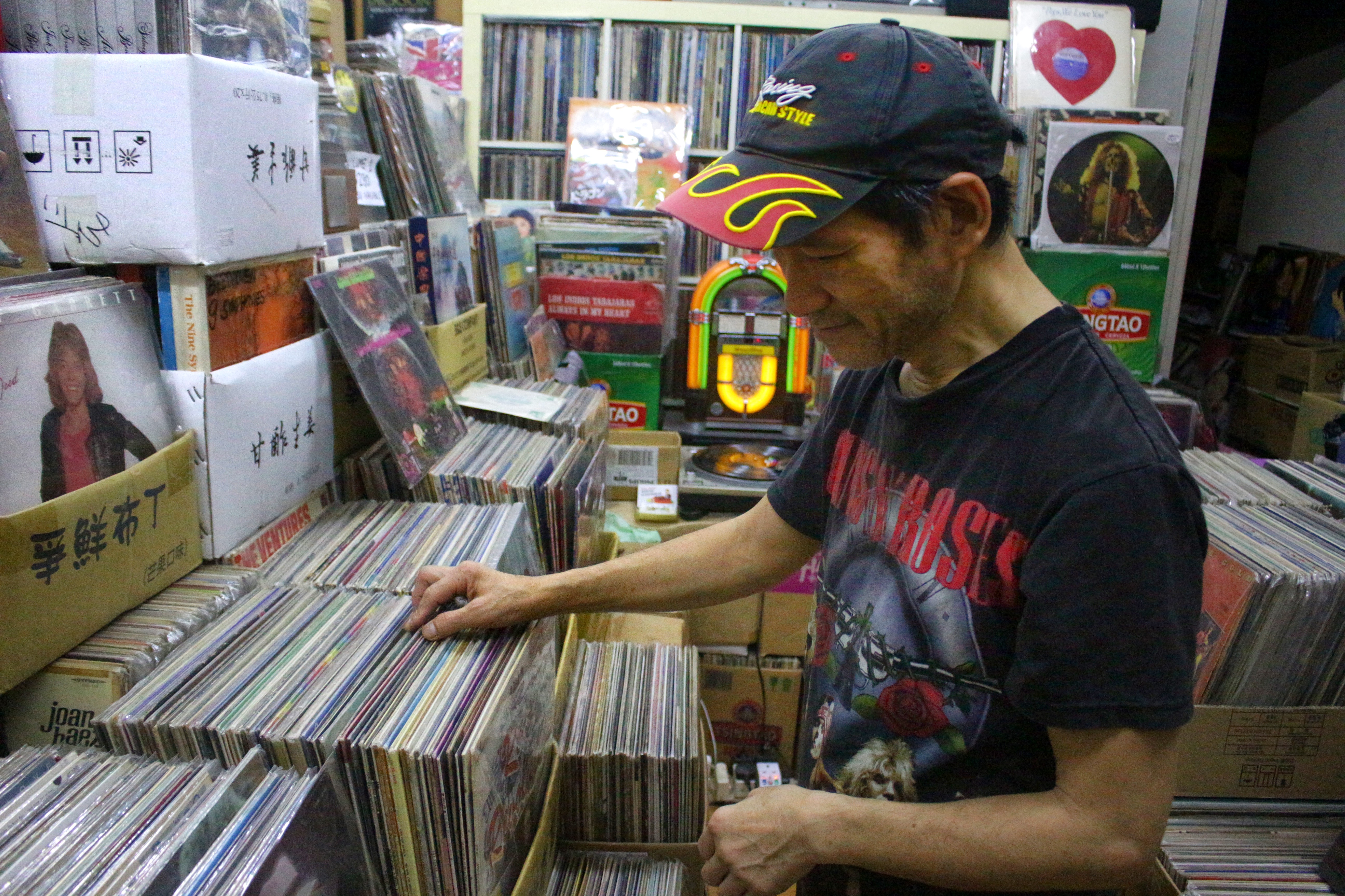 Paul Au, the self-proclaimed vinyl hero of Hong Kong, browsing through his vinyl collection. Photo by Vicky Wong.