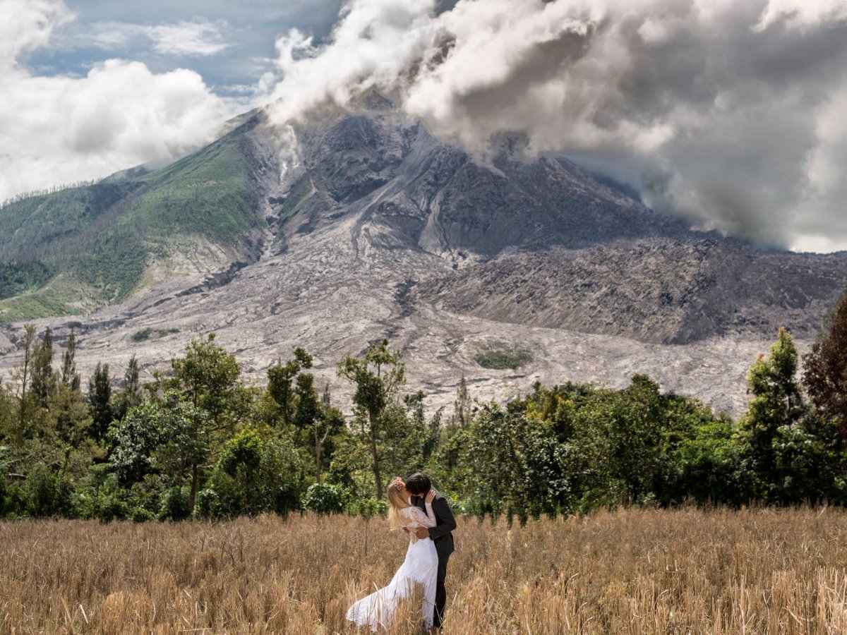 One of the many amazing wedding photos taken by Malaysian photographer Keow Wee Loong  of himself and his fiance in different countries, this one in front of Indonesia’s Mount Sinabung. Photo: Keow Wee Loong 