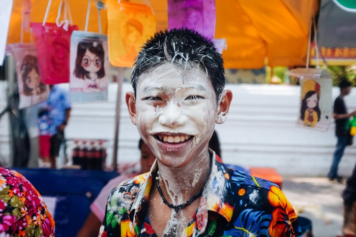 A Thai teen covers his face with powder as he celebrates Songkran Festival at Khaosan Road, April 2016. Photo: Watsamon Tri-yasakda/ Coconuts Media