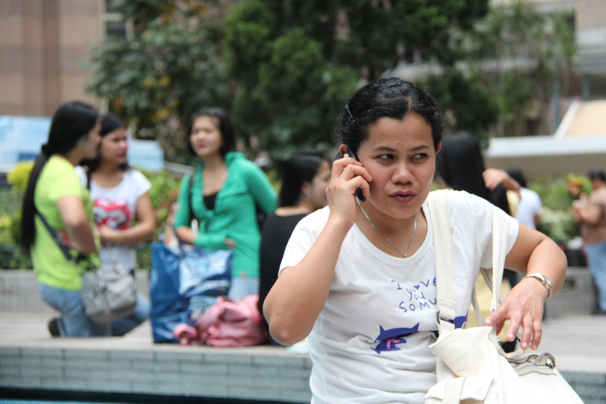 A domestic worker in Hong Kong calls homes. Photo: Flickr / KC Wong