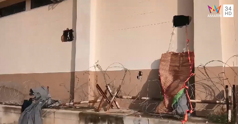 Police said 20 ethnic Uighurs bore two small holes into the wall of the center in Sadao, near Thailand’s southernmost border, using blankets to climb out. Screenshot: Amarin TV