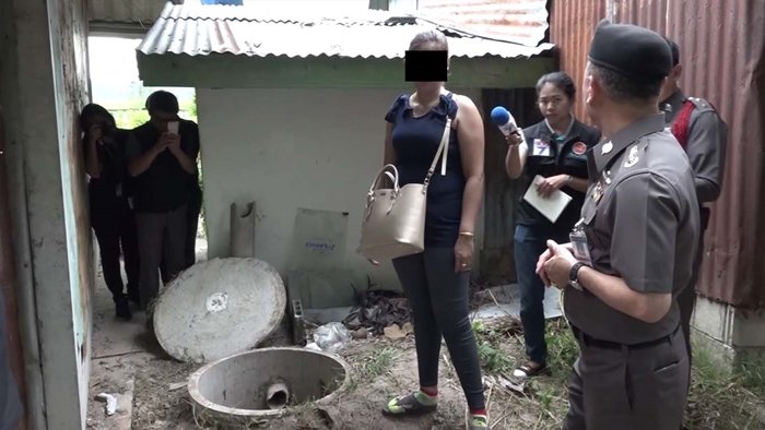 The wife stands beside the septic tank where she concealed her husband’s body. Photo: Sanook