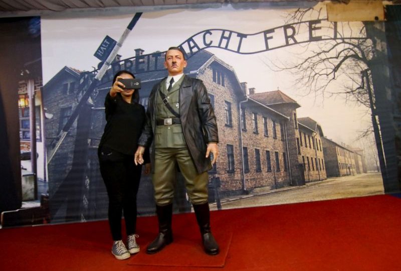 A woman take a selfie with the life-size wax replica of Adolf Hitler inside De ARCA Statue Art Museum in Yogyakarta (AFP/Henryanto)