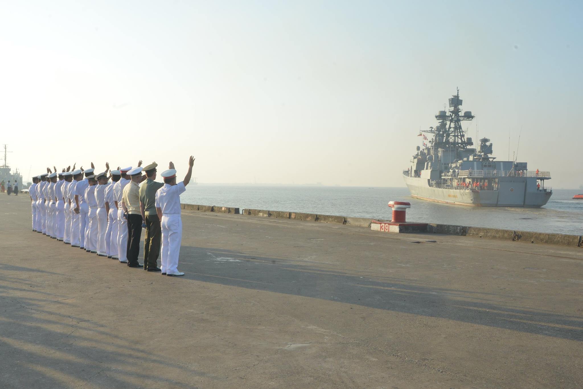Myanmar Navy officers wave goodbye to the Admiral Panteleyev
