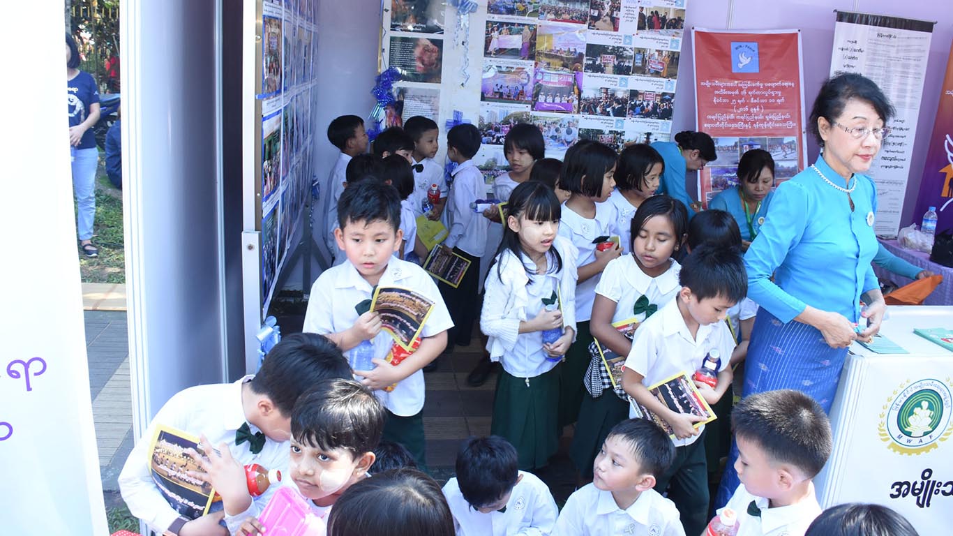 MWAF members distribute pamphlets about child abandonment at the Youth All-Round Development Festival at Yangon University in December 2017. Photo: MOI