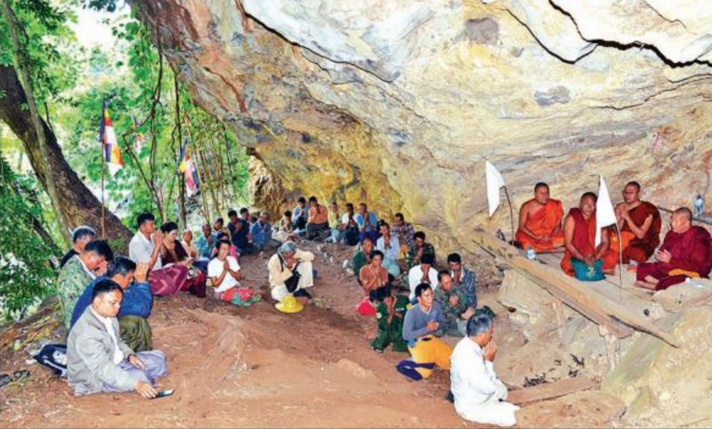 Local officials and residents receive the Five Precepts from the Mei Phone Sayadaw in a newly discovered cave in southern Shan State. Photo: Sai Zaw Latt