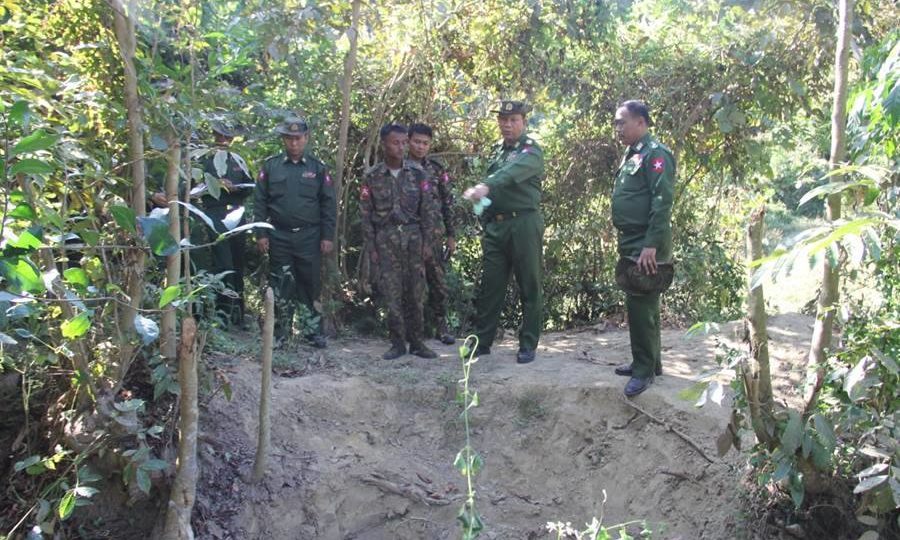 A military investigation team examines a mass grave in Inn Din village, Rakhine State.