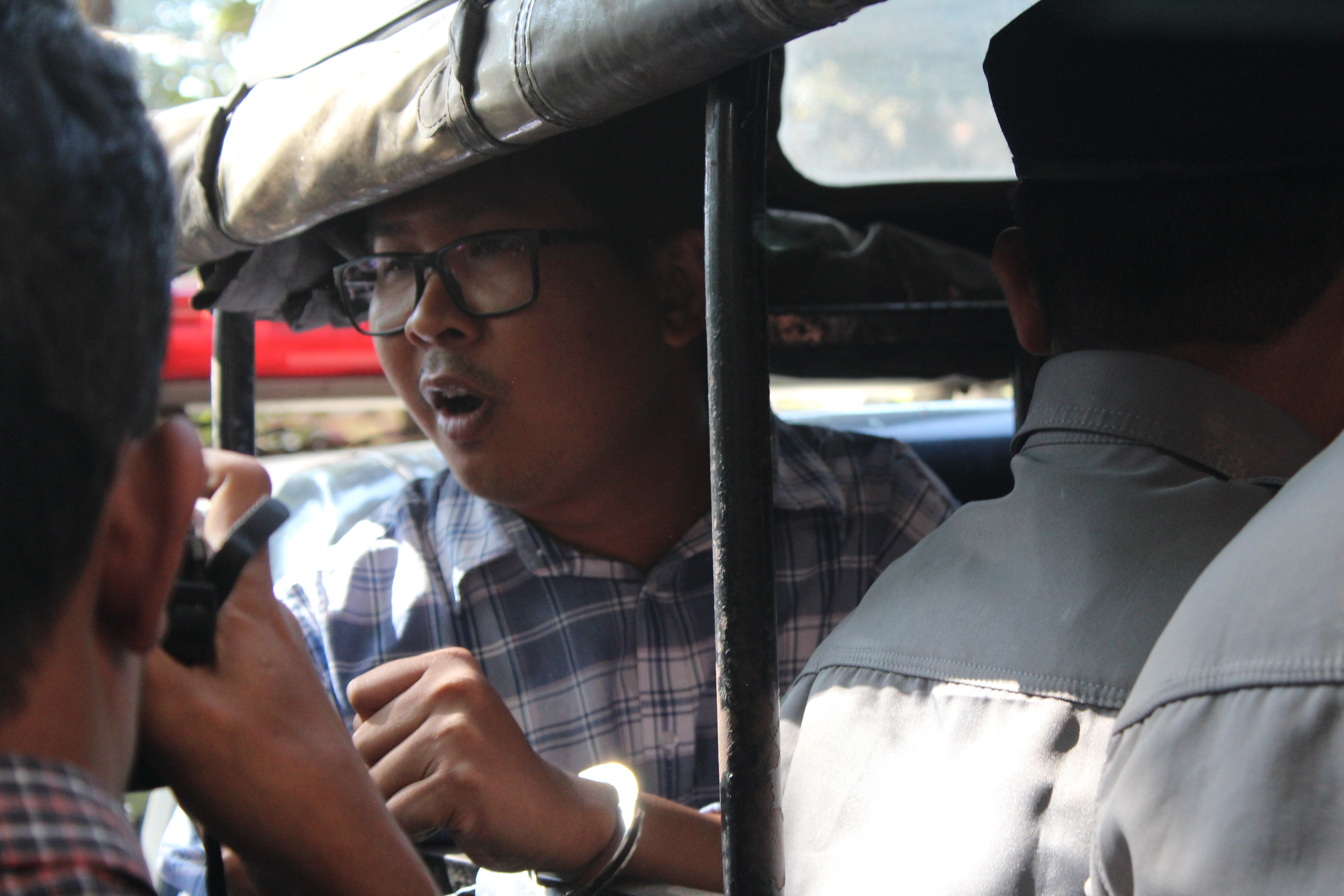 Reuters reporter Wa Lone speaks to reporters from the back of a police truck following a Jan. 23, 2018, hearing in Yangon. Photo: Jacob Goldberg