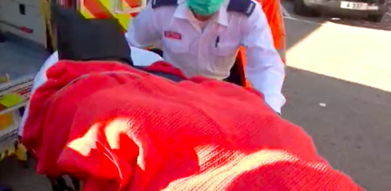 The suspect, a 42-year-old surnamed Kim, strapped to a hospital gurney yelling as he’s wheeled from the ambulance in January. Screengrab via Apple Daily video.