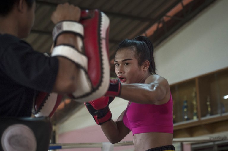 This photograph taken on December 15, 2017 shows Muay Thai boxer Nong Rose, 21, doing pad work during a training session in Thailand’s central province of Chachoengsao. AFP PHOTO / Lillian Suwanrumpha 