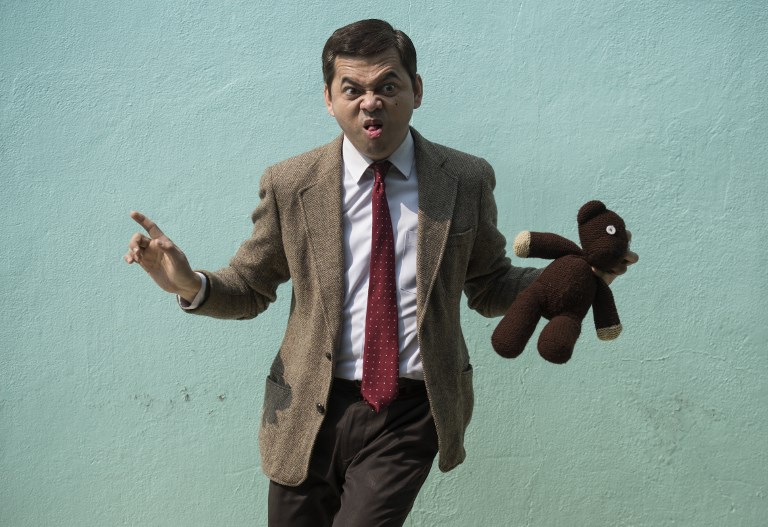 With the signature red tie, brown blazer, briefcase and teddy bear, the Thai computer technician has become a national sensation through his uncanny Mr. Bean impersonations. Photo: AFP