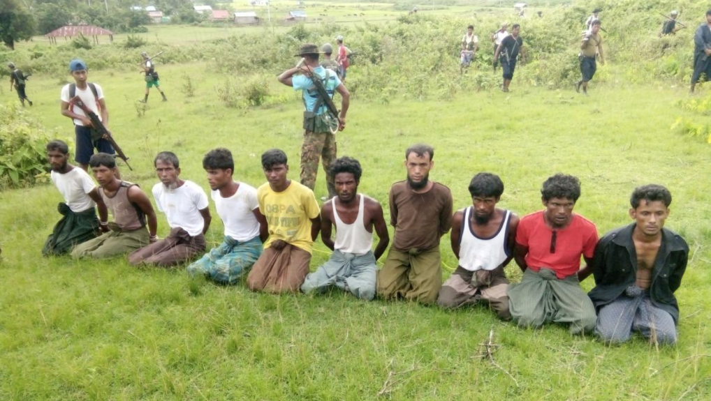 Ten Rohingya men kneel with their hands bound shortly before their extralegal execution by Myanmar security forces and Buddhist villagers in Inn Din village on Sept. 2, 2017.