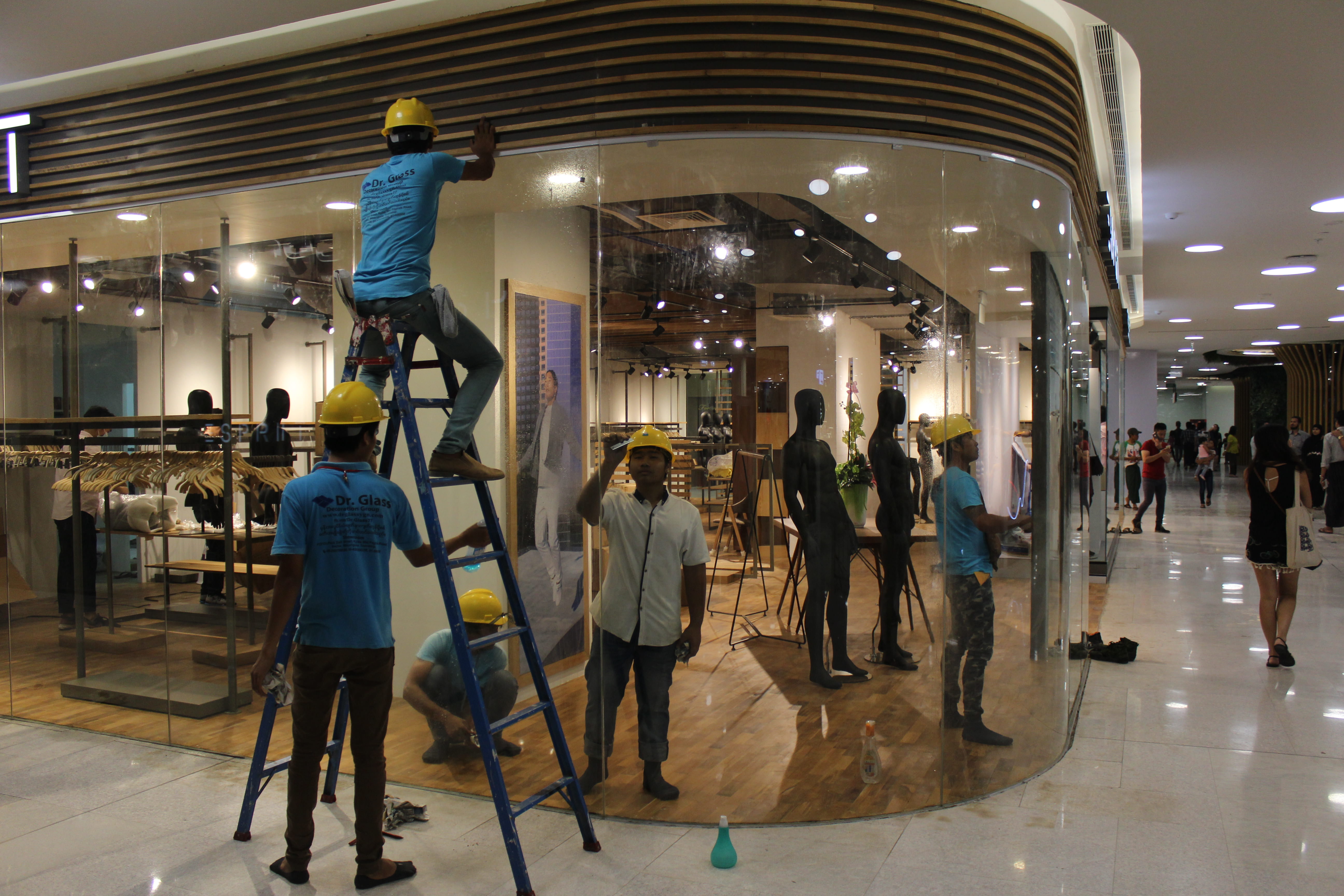Construction workers work on a shop in Yangon’s Junction City mall on its opening day on March 27, 2017. Photo: Jacob Goldberg