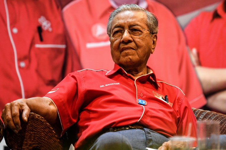 Yet-to-be re-elected Malaysian Prime Minister Mahathir Mohamad looks on during a rally ahead of the 14th general election in Malaysia’s popular island of Langkawi on April 15, 2018.
Malaysia’s veteran ex-leader Mahathir Mohamad will run at an upcoming general election on the holiday island of Langkawi, the opposition announced on April 15, as he seeks to oust the scandal-plagued government. / AFP PHOTO / Mohd RASFAN