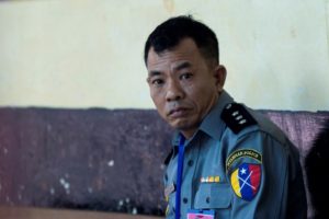 Police Captain Moe Yan Naing waits outside the courthouse before attending the ongoing trial of two detained journalists in Yangon on April 20, 2018. Photo: AFP