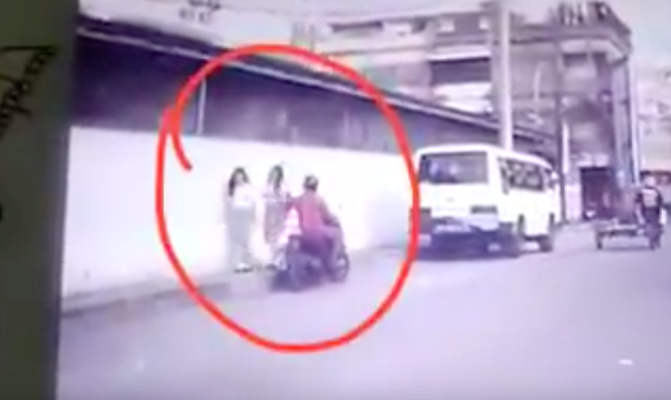 Video screengrab showing a motorcyclist groping a high school girl’s breasts in Medan on April 19, 2018.