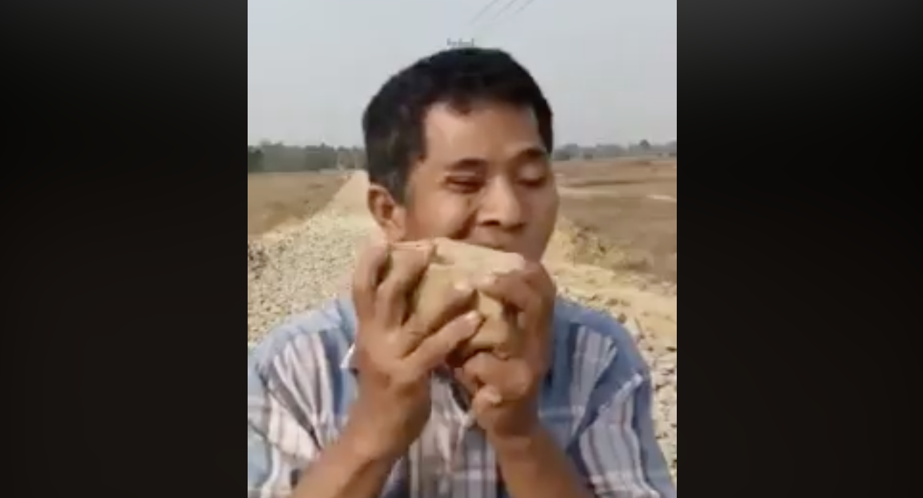 Rakhine State resident Win Aung chews a rock to protest his area’s poor roads.