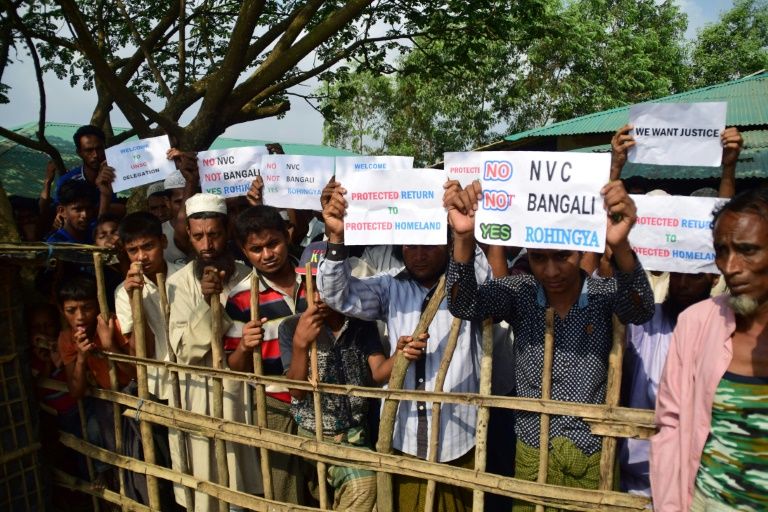 Rohingya refugees hold placards to members of United nations Security Council team during their visit to Kutupalong refugee camp in Bangladesh’s Ukhia’s district on April, 29, 2018. Photo: Sam JAHAN / AFP