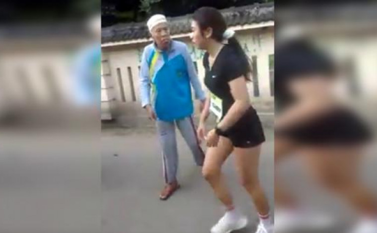 A woman participating in a race in Jogjakarta on May 1, 2018 being confronted by an angry old man for her “inappropriate clothing”. Photo: Youtube screengrab