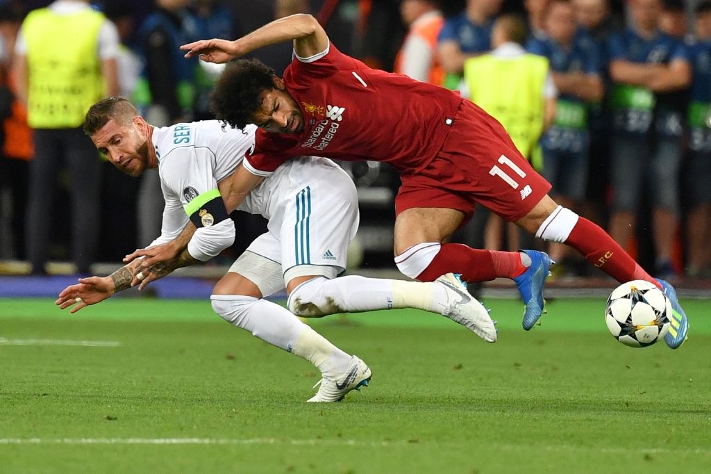 Liverpool’s Egyptian forward Mohamed Salah (R) falls with Real Madrid’s Spanish defender Sergio Ramos leading to Salah being injured during the UEFA Champions League final football match between Liverpool and Real Madrid at the Olympic Stadium in Kiev, Ukraine, on May 26, 2018. 
Photo: GENYA SAVILOV / AFP