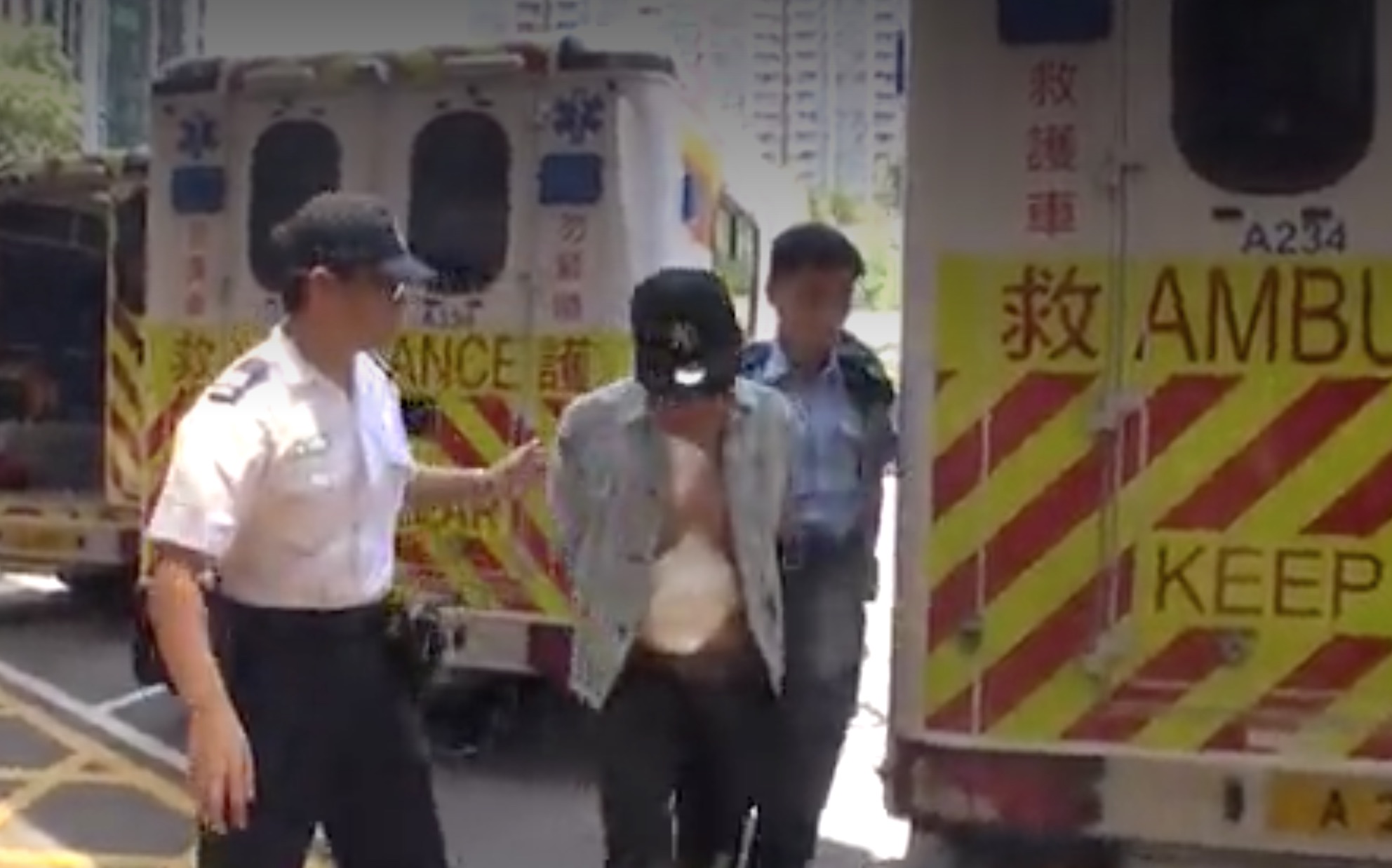 The suspect being led away by authorities. Picture: Apple Daily screen grab