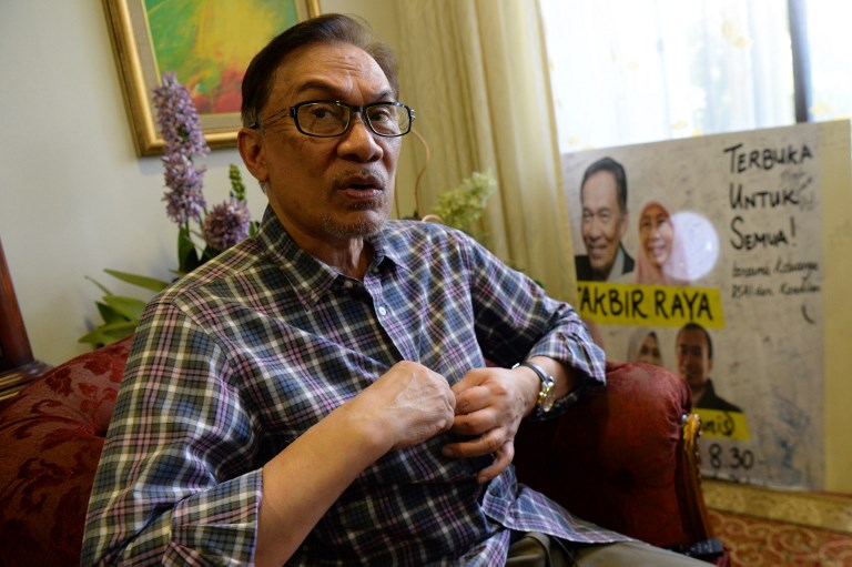 Newly released Malaysian politician Anwar Ibrahim gestures during an interview with AFP at his house in Kuala Lumpur on May 17, 2018. AFP PHOTO / Roslan Rahman