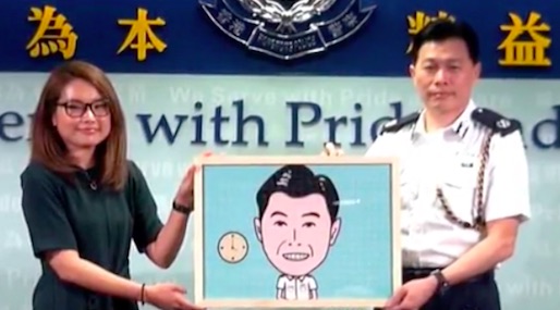 Steve Hui is presented with a puzzle of him next to a clock showing the time 4pm, a nod to a nickname he earned during the Umbrella Movement protests, “4pm Hui Sir”. Screengrab via Apple Daily video.