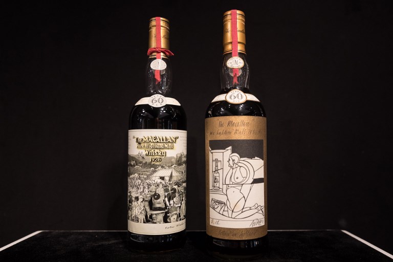 Two bottles of whisky, Macallan Peter Blake 1926 (L) and Valerio Adami 1926 (R), are displayed ahead of a Bonhams auction in Hong Kong on May 18, 2018.
AFP PHOTO / Dale de la Rey