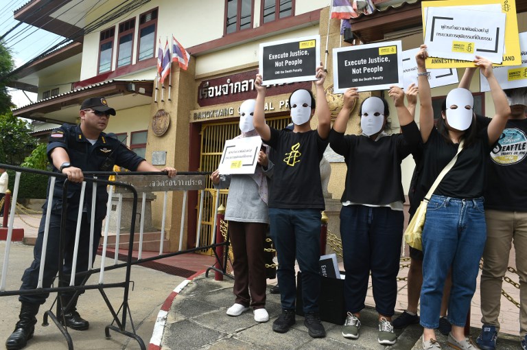 Activists from Amnesty International display placards on a stage as they protest at the entrance of the Bang Kwang high-security prison in the outskirts of Bangkok on June 19, 2019. Photo: AFP