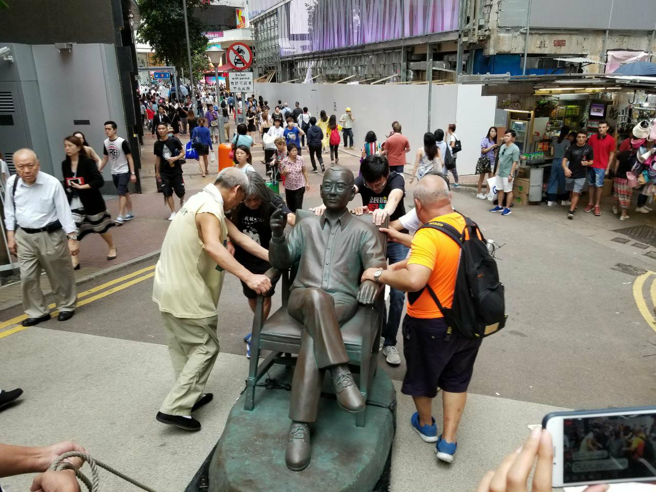 Activists remove the statute of Liu Xiaobo from outside Times Square in Causeway Bay. Picture: Supplied