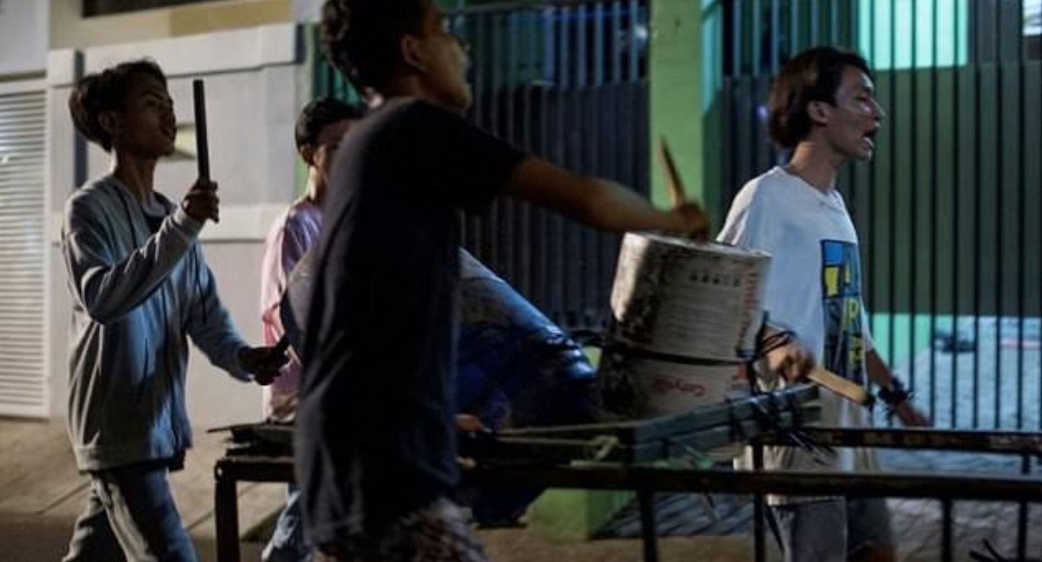 In this photograph taken early on May 19, 2018, youths sing and bang on improvised drums as they walk around their neighborhood to wake up residents for Sahur, the pre-dawn meal eaten before the start of the fasting day throughout the holy month of Ramadan, in Jakarta. Most of Jakarta is fast asleep at 2:00 am, but for Fajar Ramadin and his pint-sized comrades it’s time to wake up the neighbourhood. The motley group of children yell and bang on tambourines and drums as they roam the quiet streets of Indonesia’s capital on a mission to stir sleeping residents for a pre-dawn meal. BAY ISMOYO / AFP