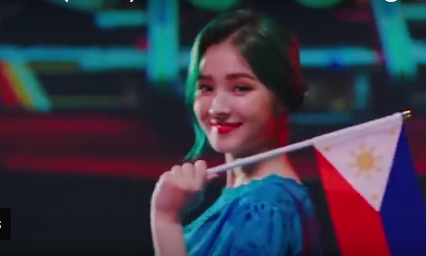 Nancy McDonnie proudly holds the Philippine flag. Screenshot from Baam’s music video.