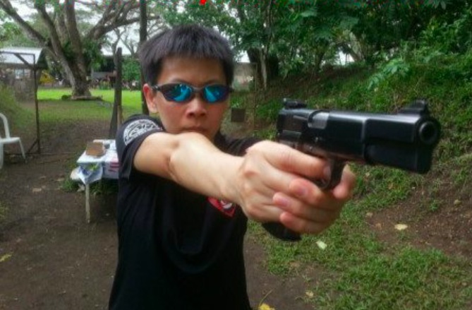 Ada Tsim wielding a gun on a bodyguard company’s website. Photo via Facebook.