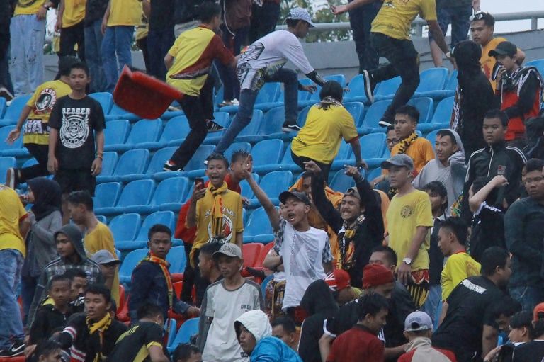 Irate spectators throw chairs ripped from the stands during the league football match between Sriwijaya FC and Arema FC at Indonesia’s Gelora Sriwijaya Stadium. AFP PHOTO