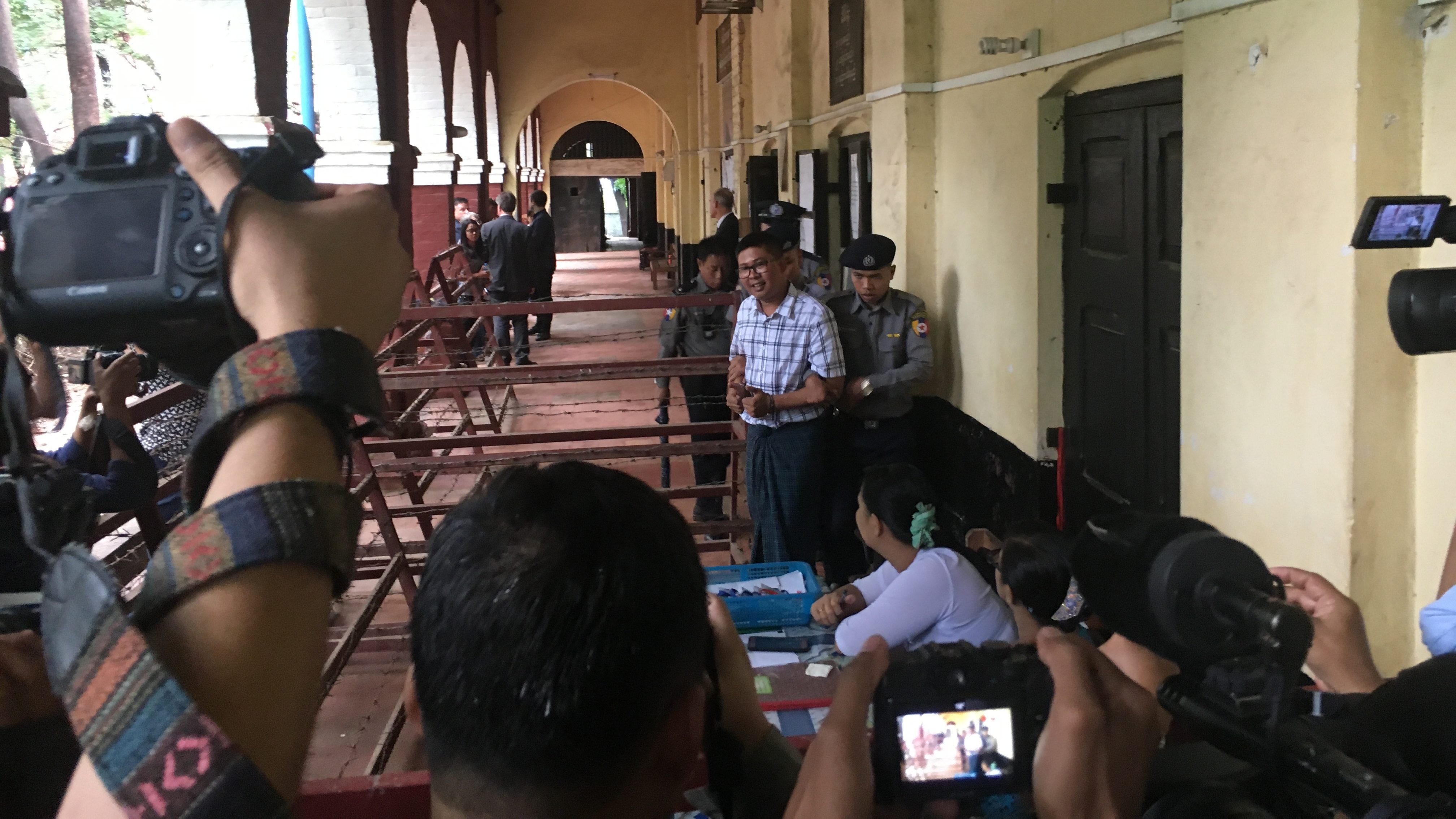 Reuters reporter Wa Lone is escorted from the Insein Township courthouse after testifying on July 16, 2018. His testimony continued on July 17. Photo: Jacob Goldberg