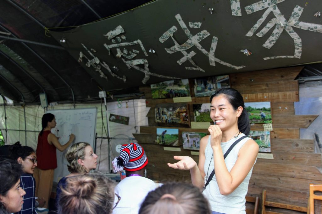 Mapopo Community Farm co-founder Becky Au tells visitors about farmers' struggles.