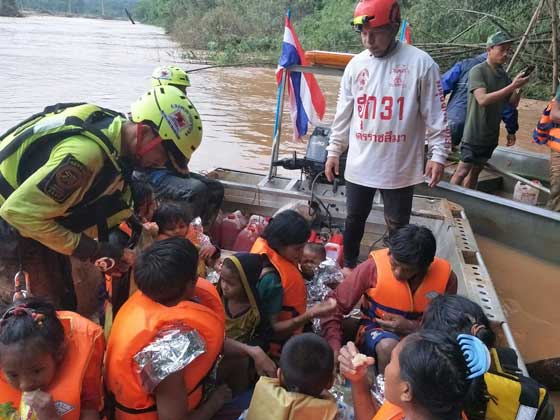 This handout photo from the Thai Rescue Team released on Friday shows a Thai Rescue Team volunteer group rescuing flood survivors, including a baby trapped in a remote village, close to the swollen river in Attapeu province. AFP PHOTO / THAI RESCUE TEAM
