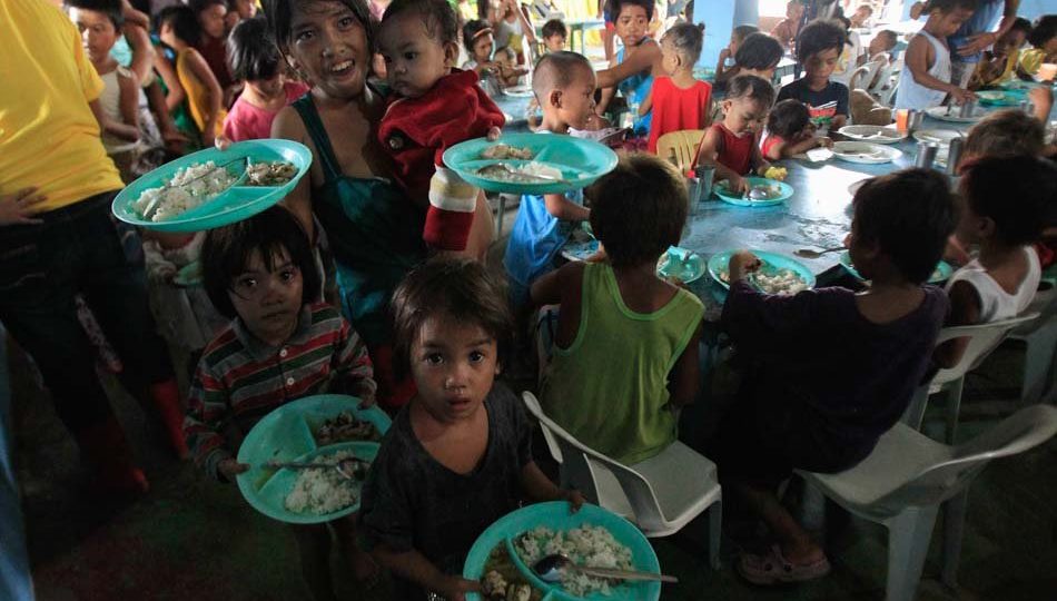 A feeding program conducted by a church in Manila’s Baseco compound. Photo via ABS-CBN. 
